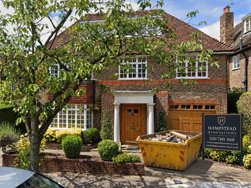 Church Mount, Hampstead Garden Suburb: brick house with a Hampstead Renovations site board and a skip on the drive