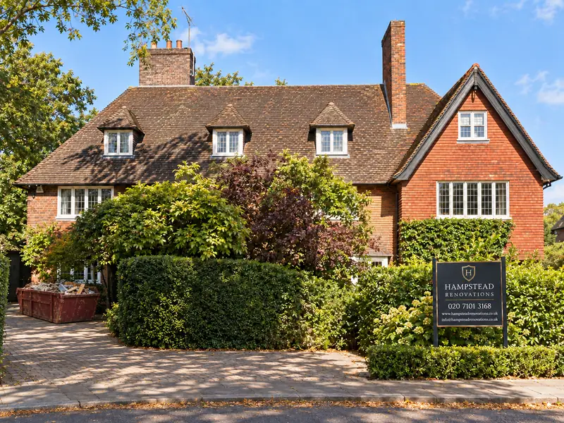 Wildwood Road, Hampstead Garden Suburb: Arts and Crafts house with a Hampstead Renovations site board and a skip on the drive